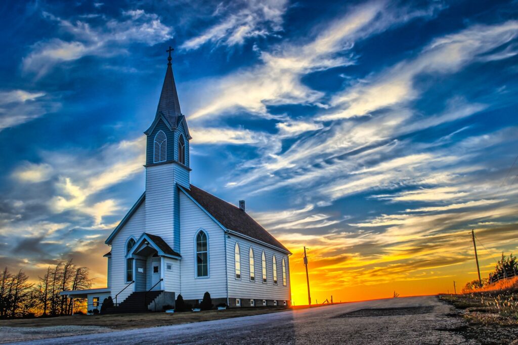 Church silhouette against sunset sky